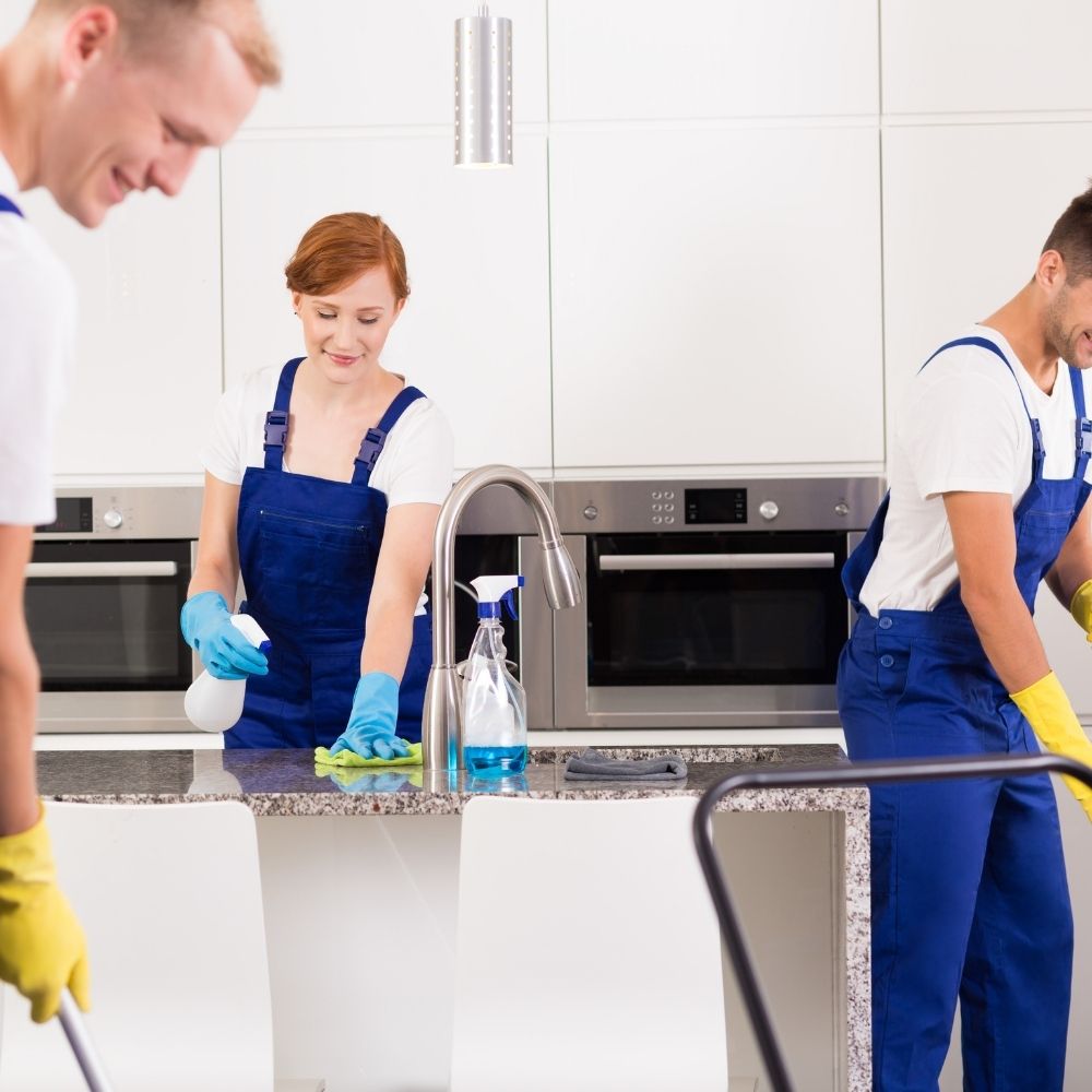 a picture of house cleaners cleaning a kitchen